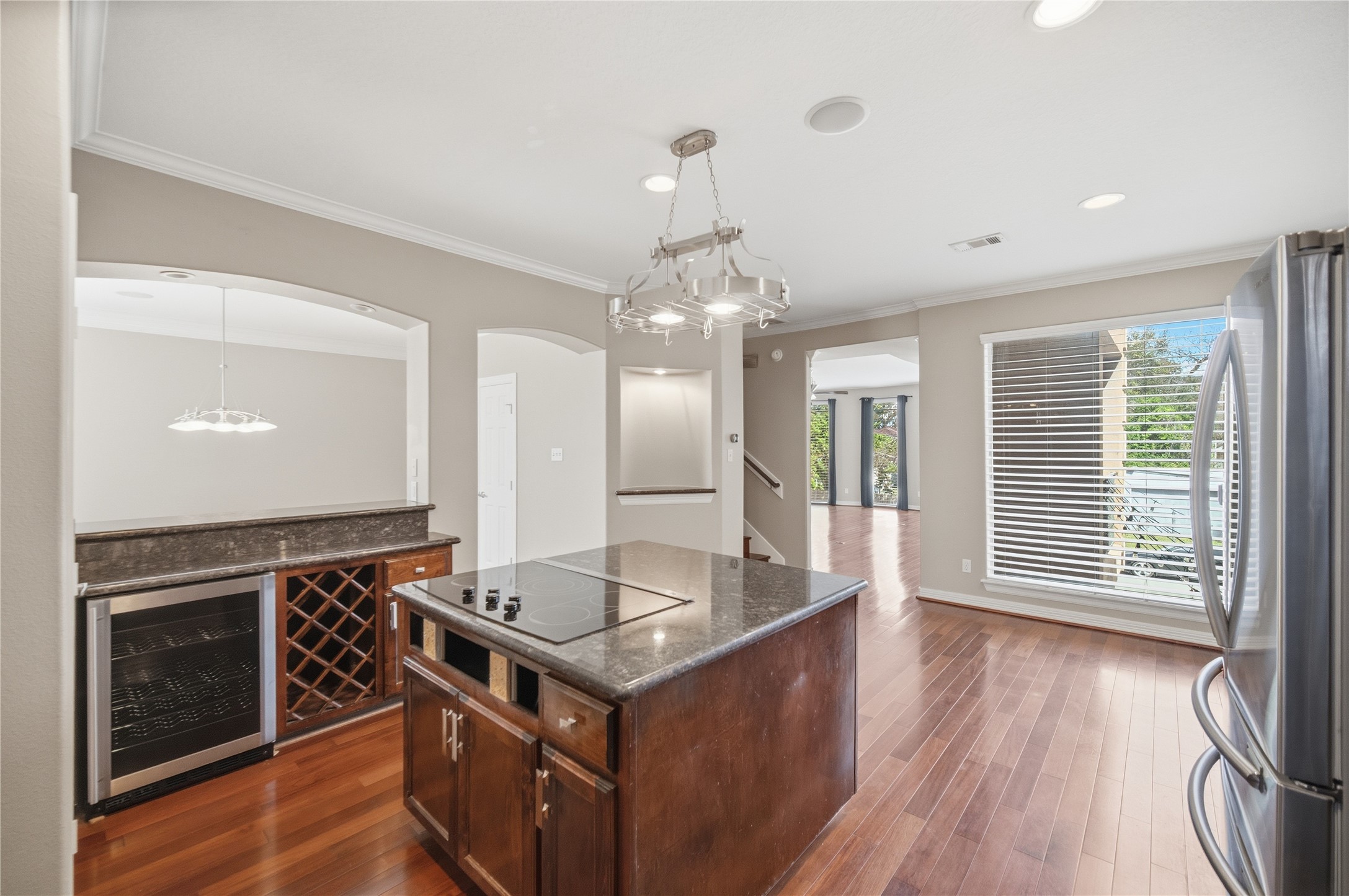 1316 Cleburne Street, Unit B Houston, TX 77004 - Photo 12 of 30 Luxurious kitchen with an electric cooktop island, ample prep space, and generous storage, complemented by a stylish beverage bar.