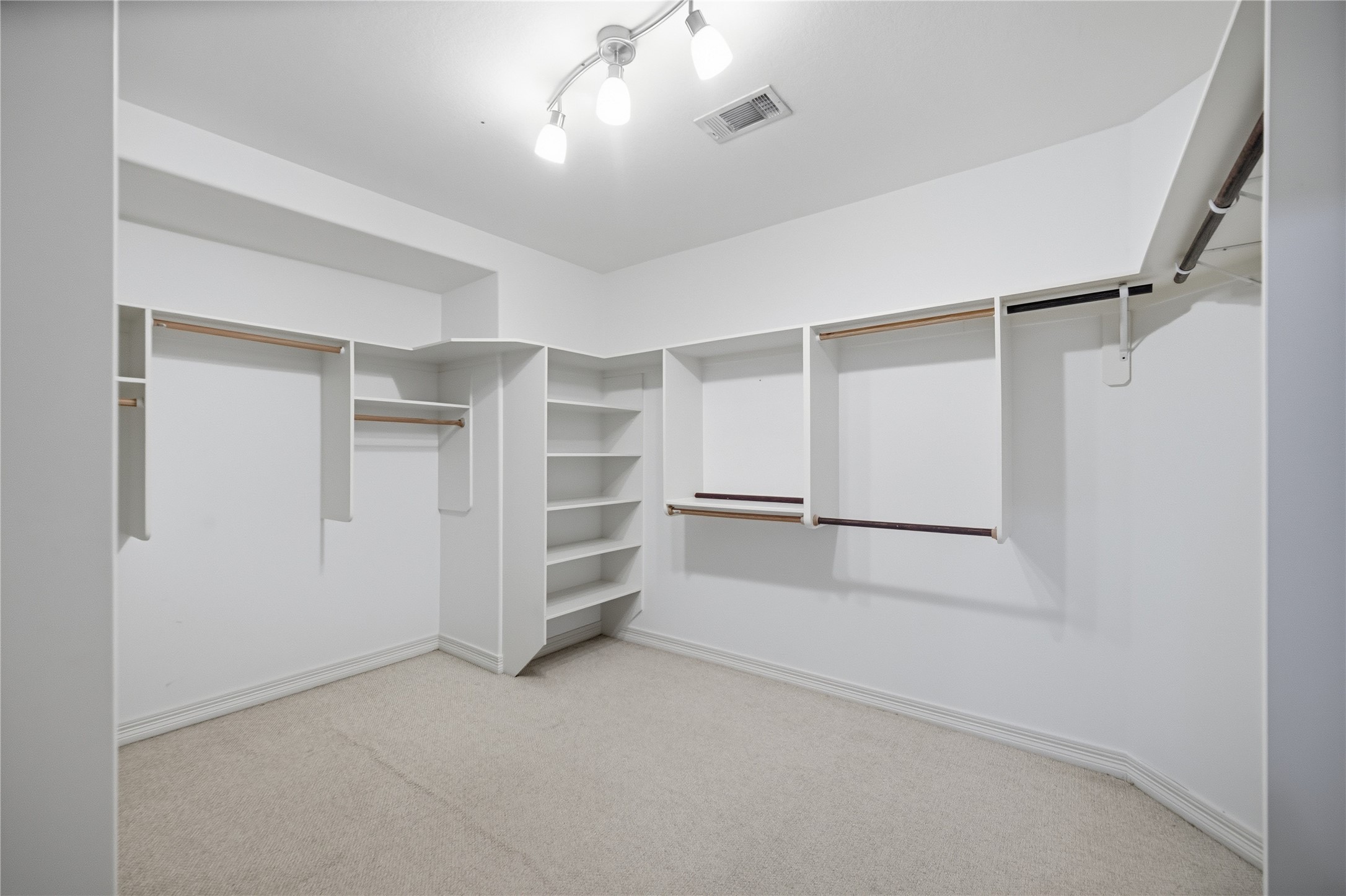 1316 Cleburne Street, Unit B Houston, TX 77004 - Photo 21 of 30 The primary closet is spacious and features built-in shelving, providing plenty of room for organizing clothes and shoes.