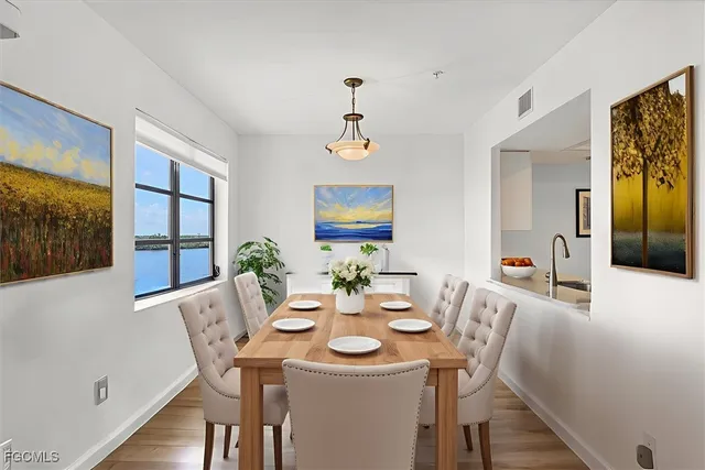 a view of a dining room with furniture window and wooden floor