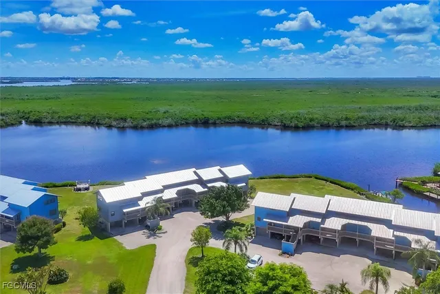 an aerial view of lake and residential houses with outdoor space