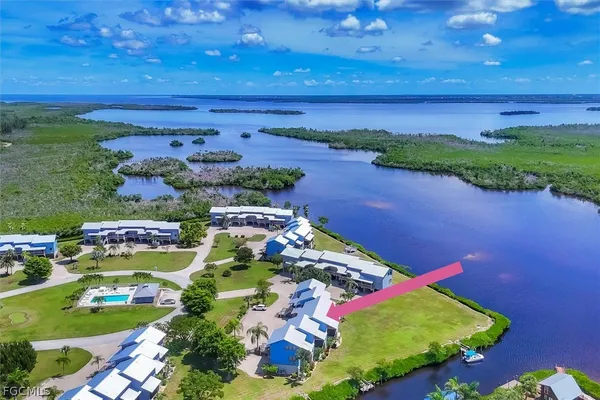 an aerial view of a house with a garden and lake view