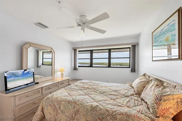 a bedroom with a bed and a book shelf