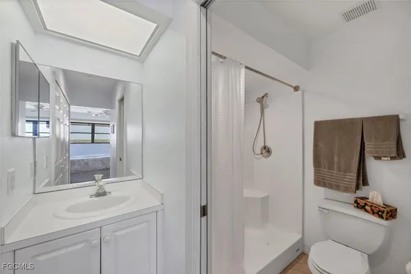 a bathroom with a sink toilet and mirror