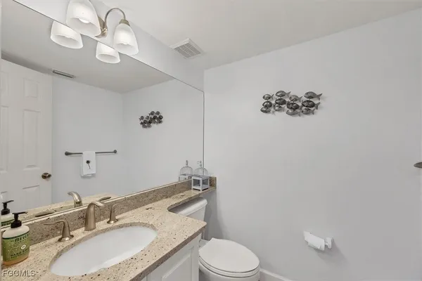 a kitchen with stainless steel appliances a stove a sink a microwave and cabinets