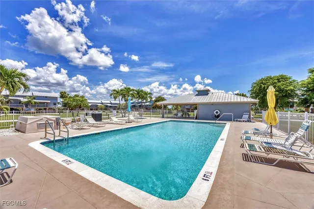 a view of a swimming pool with outdoor seating