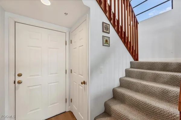 an aerial view of lake and residential houses with outdoor space
