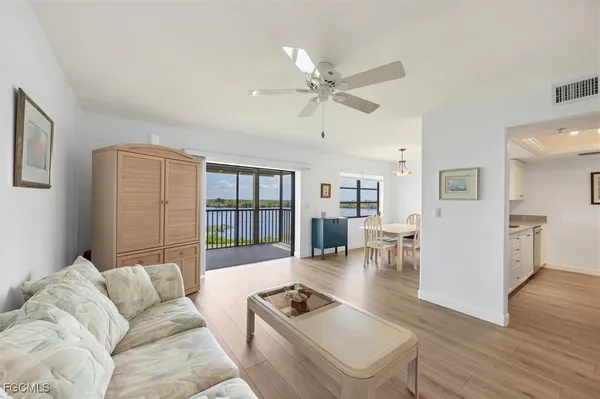a living room with furniture and a wooden floor