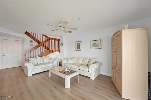 a living room with furniture and a wooden floor