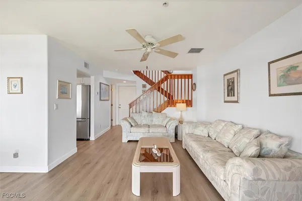 a kitchen with stainless steel appliances granite countertop a sink refrigerator and microwave