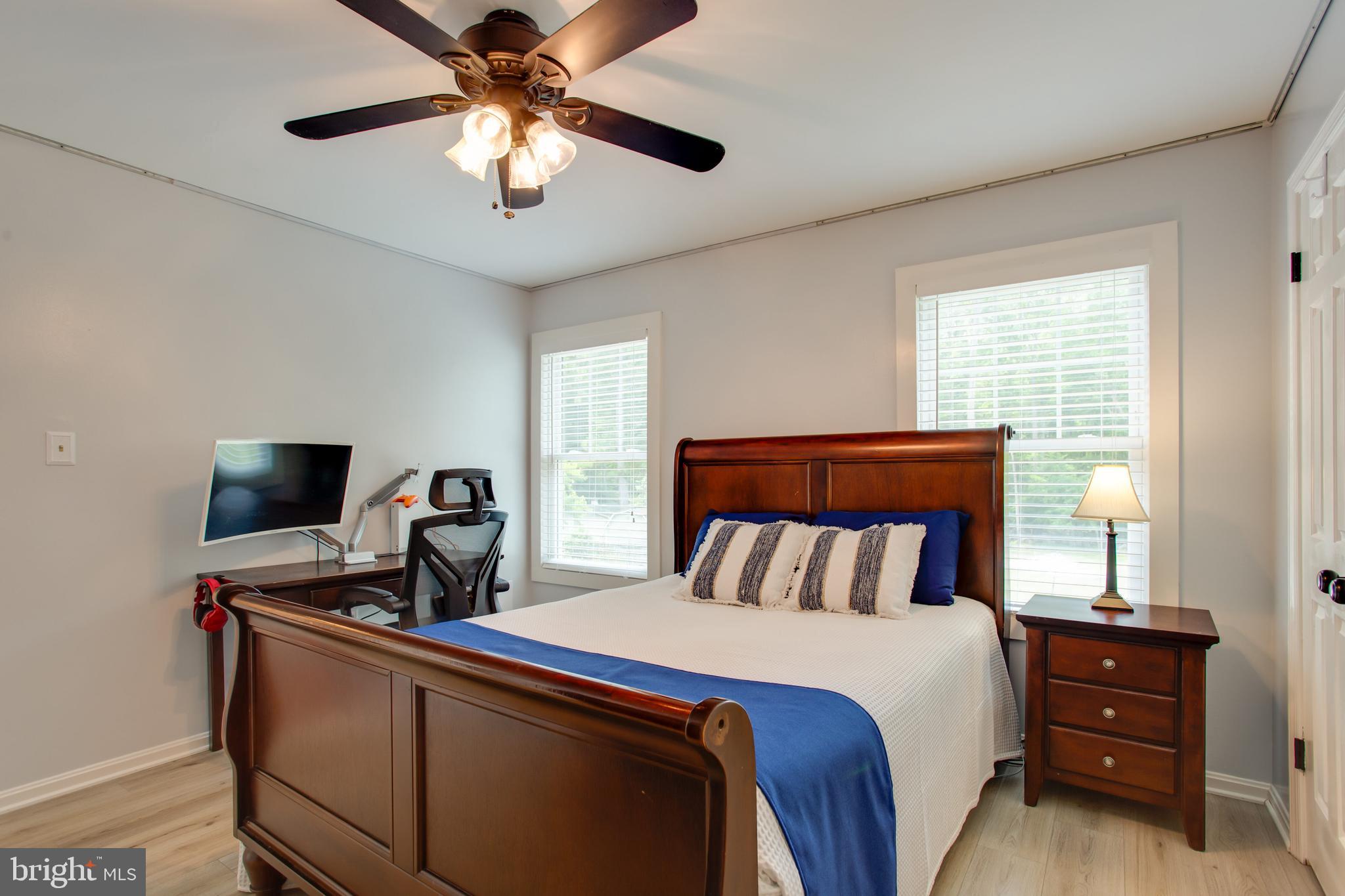 2904 Eutaw Forest Drive Waldorf, MD 20603 - Photo 14 of 59 a bedroom with a bed and a chandelier