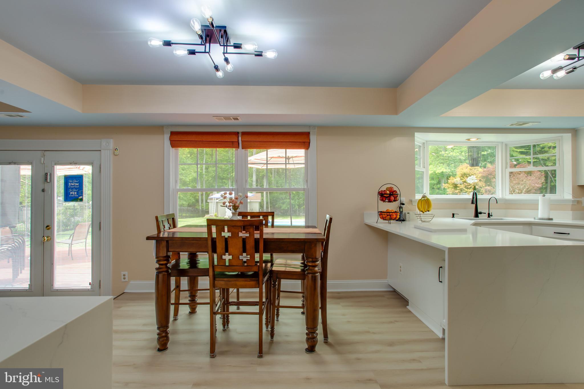 2904 Eutaw Forest Drive Waldorf, MD 20603 - Photo 27 of 59 a view of a dining room with furniture a chandelier and wooden floor