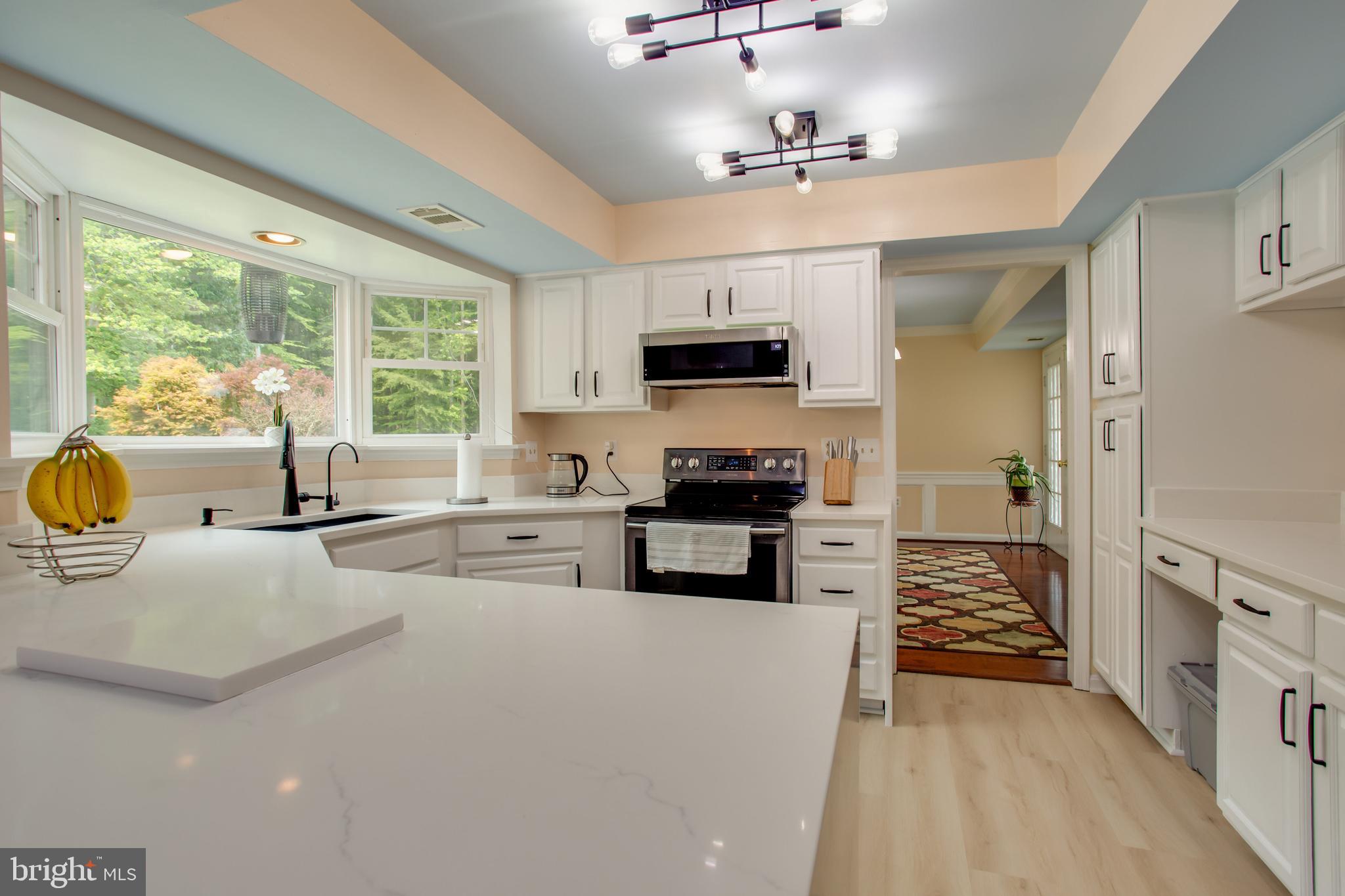 2904 Eutaw Forest Drive Waldorf, MD 20603 - Photo 32 of 59 a kitchen with stainless steel appliances a stove sink microwave and cabinets