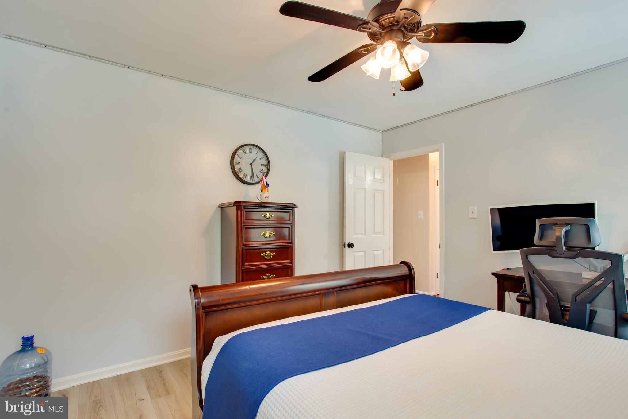 2904 Eutaw Forest Drive Waldorf, MD 20603 - Photo 41 of 59 a bedroom with a bed and a chandelier