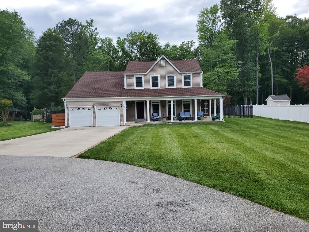 2904 Eutaw Forest Drive Waldorf, MD 20603 - Photo 58 of 59 a front view of a house with a garden and trees