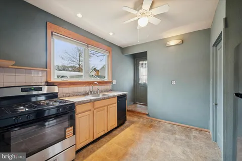 a kitchen with stainless steel appliances granite countertop a stove and a sink