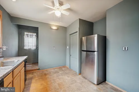 a view of a kitchen with a sink and a refrigerator