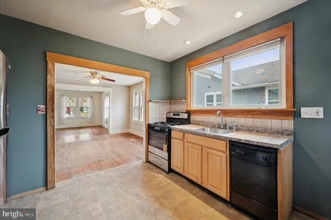 a open kitchen with a sink and stove