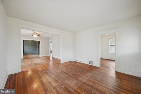 a view of an empty room and wooden floor