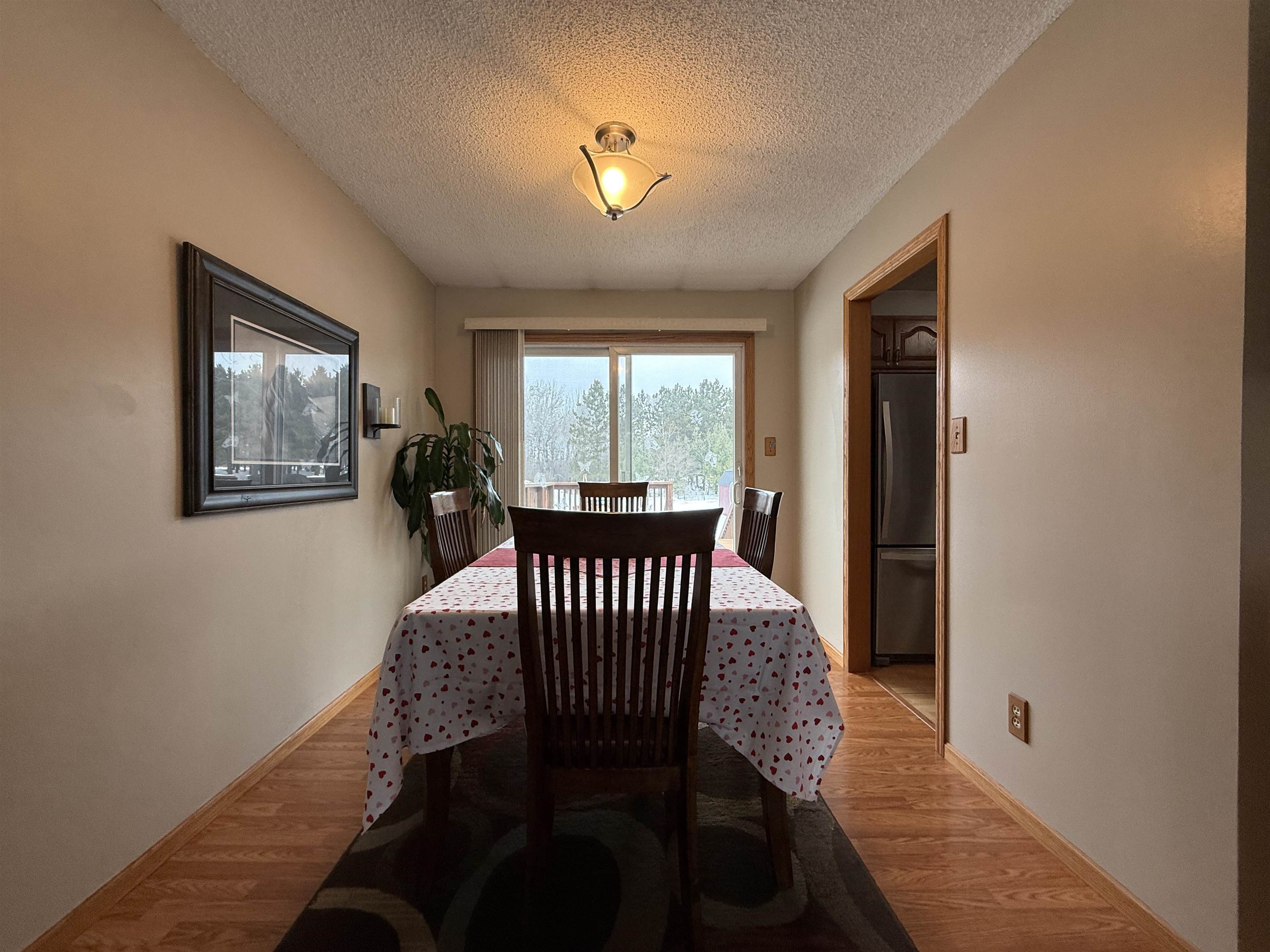 3991 Dillon Road Hibbing, MN 55746 - Photo 12 of 25 Dining space with wood finished floors and a textured ceiling