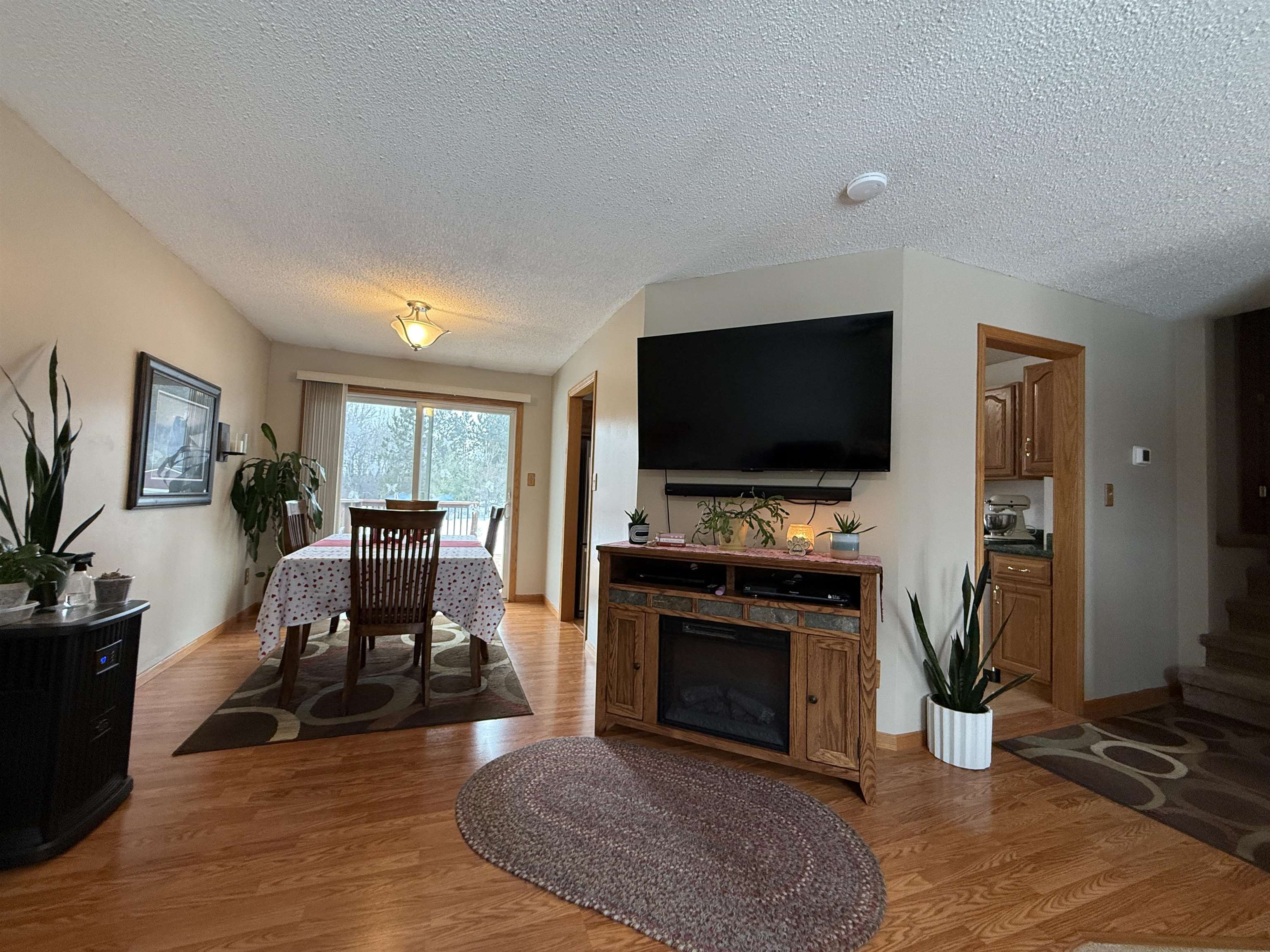 3991 Dillon Road Hibbing, MN 55746 - Photo 13 of 25 Living area with wood finished floors and a textured ceiling