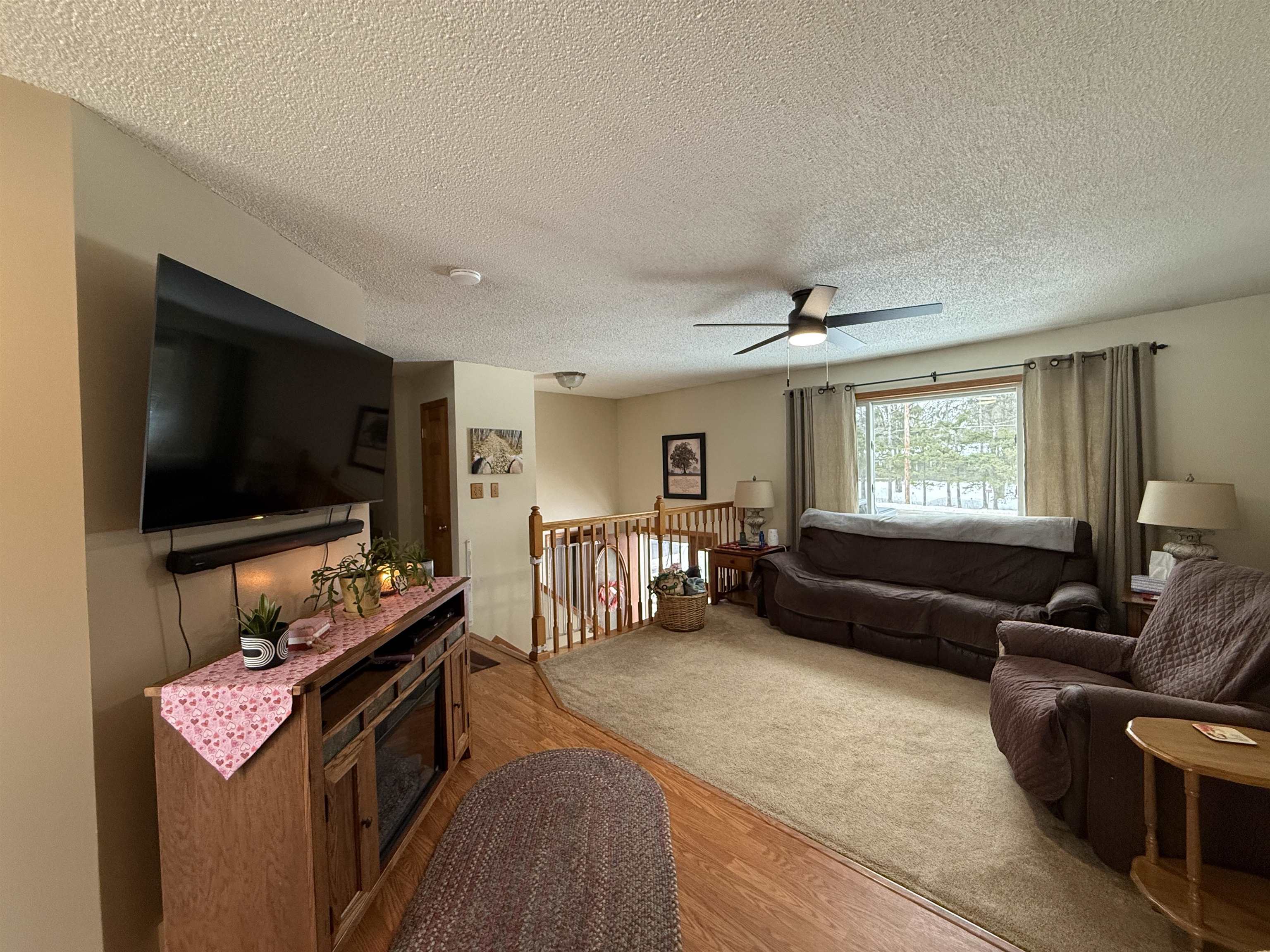 3991 Dillon Road Hibbing, MN 55746 - Photo 14 of 25 Living area featuring wood finished floors, a ceiling fan, and a textured ceiling