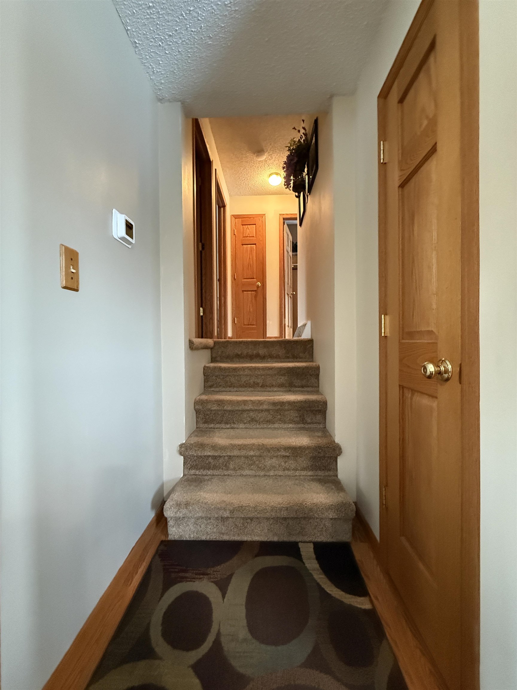 3991 Dillon Road Hibbing, MN 55746 - Photo 16 of 25 Staircase with baseboards and a textured ceiling