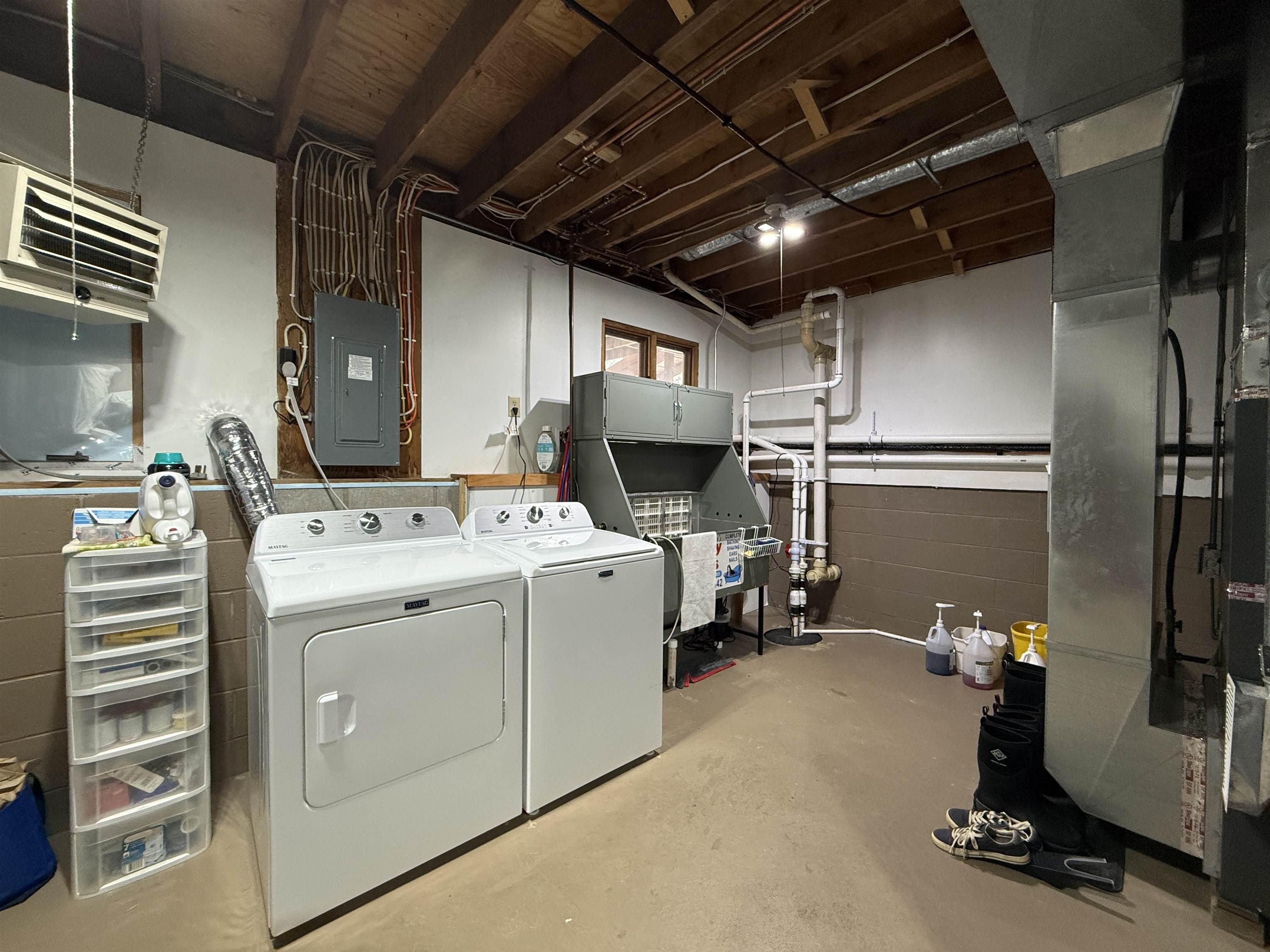 3991 Dillon Road Hibbing, MN 55746 - Photo 23 of 25 Laundry area with unfinished concrete floors, electric panel, heating unit, and washing machine and clothes dryer