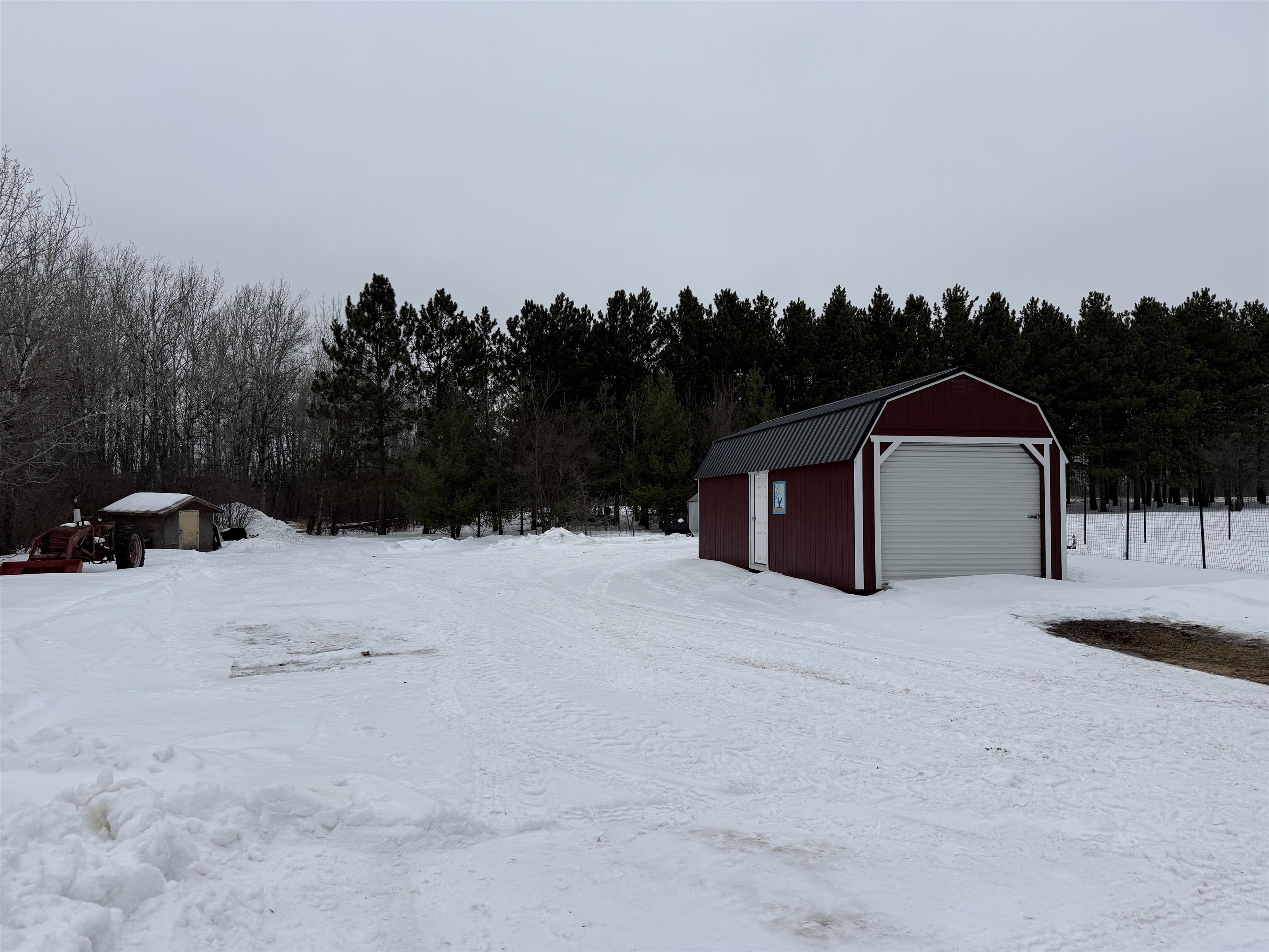 3991 Dillon Road Hibbing, MN 55746 - Photo 4 of 25 Yard covered in snow with an outbuilding
