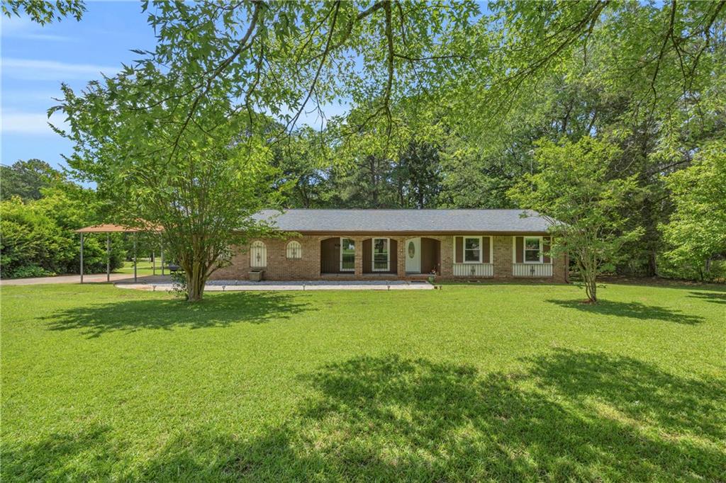 676 Smith Store Road Covington, GA 30016 - Photo 1 of 1 a front view of a house with garden