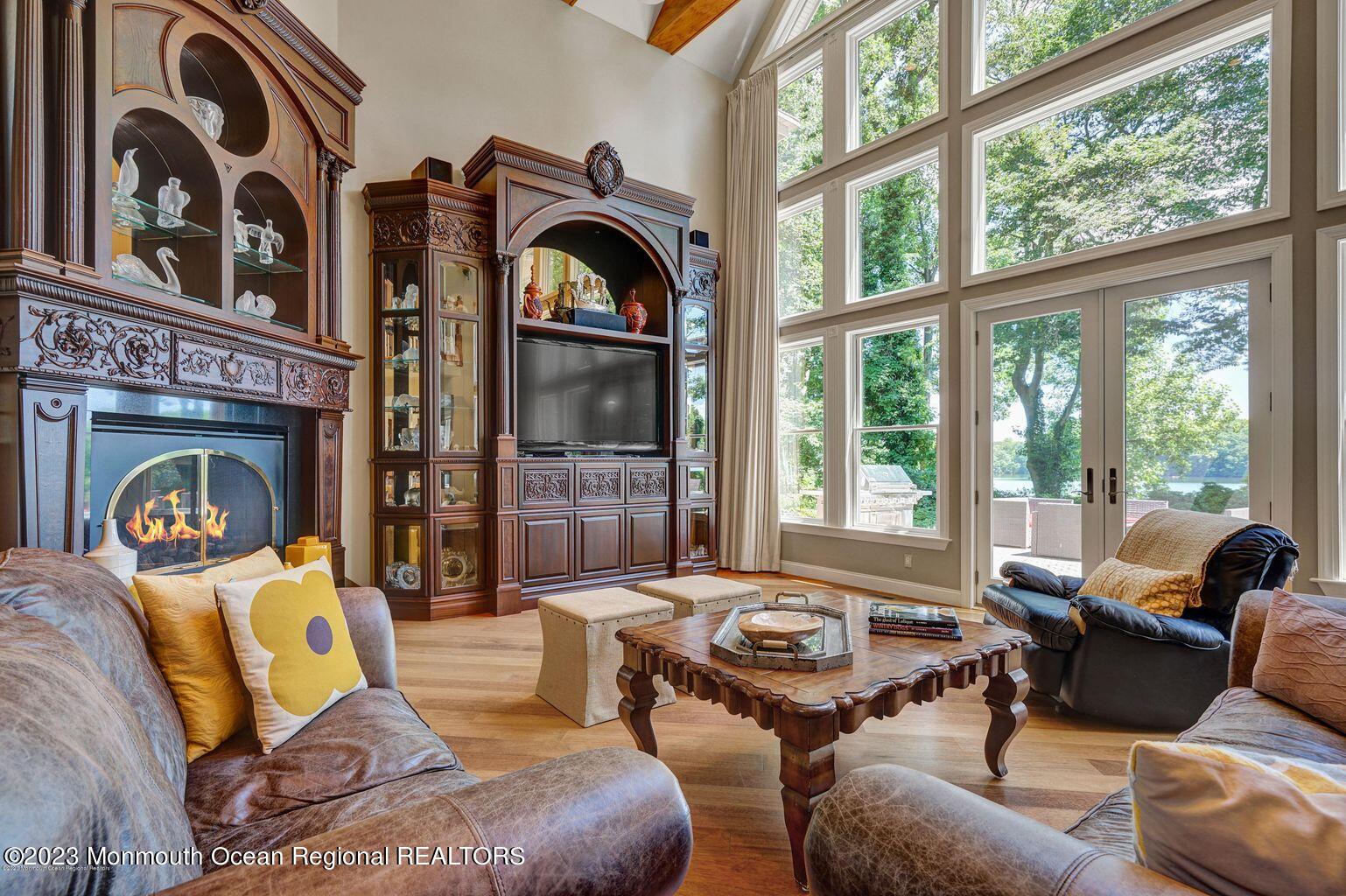 67 Phalanx Road Lincroft, NJ 07738 - Photo 12 of 55 a living room with furniture and a floor to ceiling window