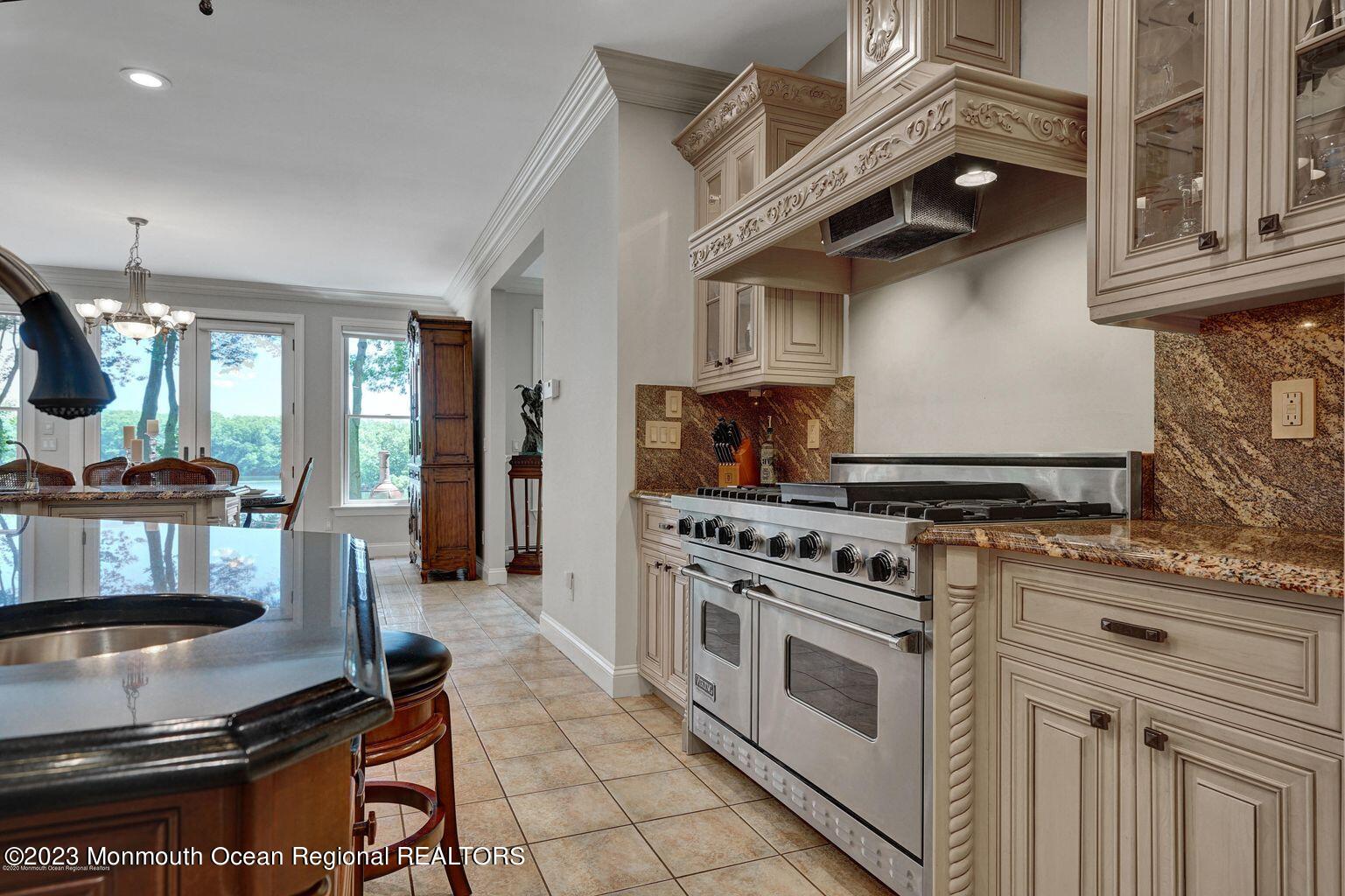 67 Phalanx Road Lincroft, NJ 07738 - Photo 15 of 55 a kitchen with stainless steel appliances granite countertop a stove and a sink