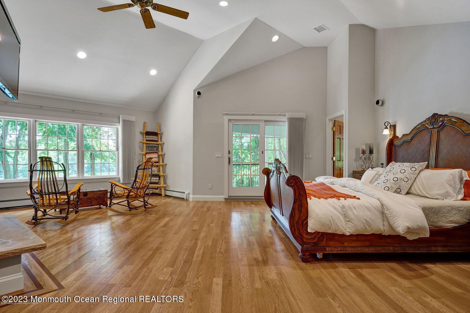 67 Phalanx Road Lincroft, NJ 07738 - Photo 24 of 55 a bedroom with a bed and large windows
