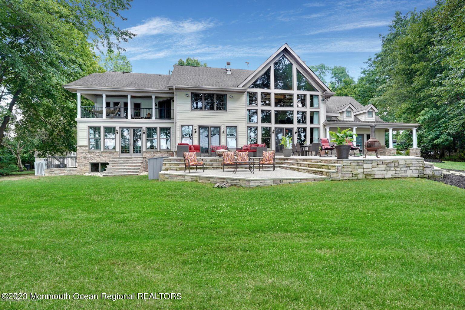 67 Phalanx Road Lincroft, NJ 07738 - Photo 3 of 55 a front view of a house with swimming pool and garden