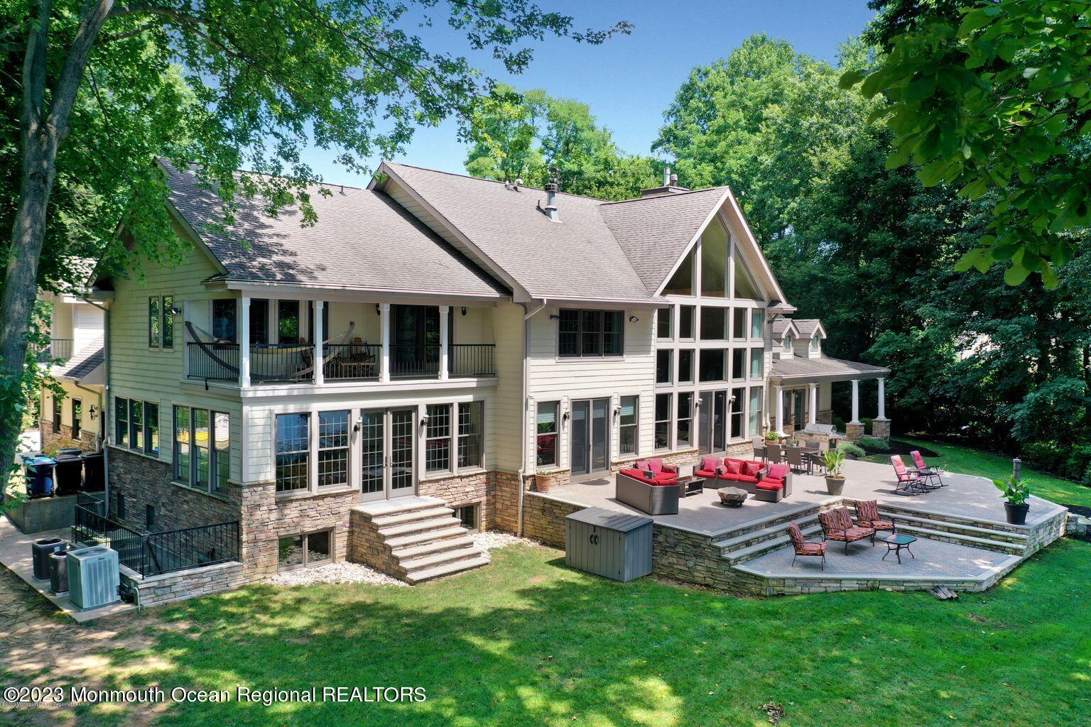 67 Phalanx Road Lincroft, NJ 07738 - Photo 34 of 55 a front view of a house with a yard table and chairs