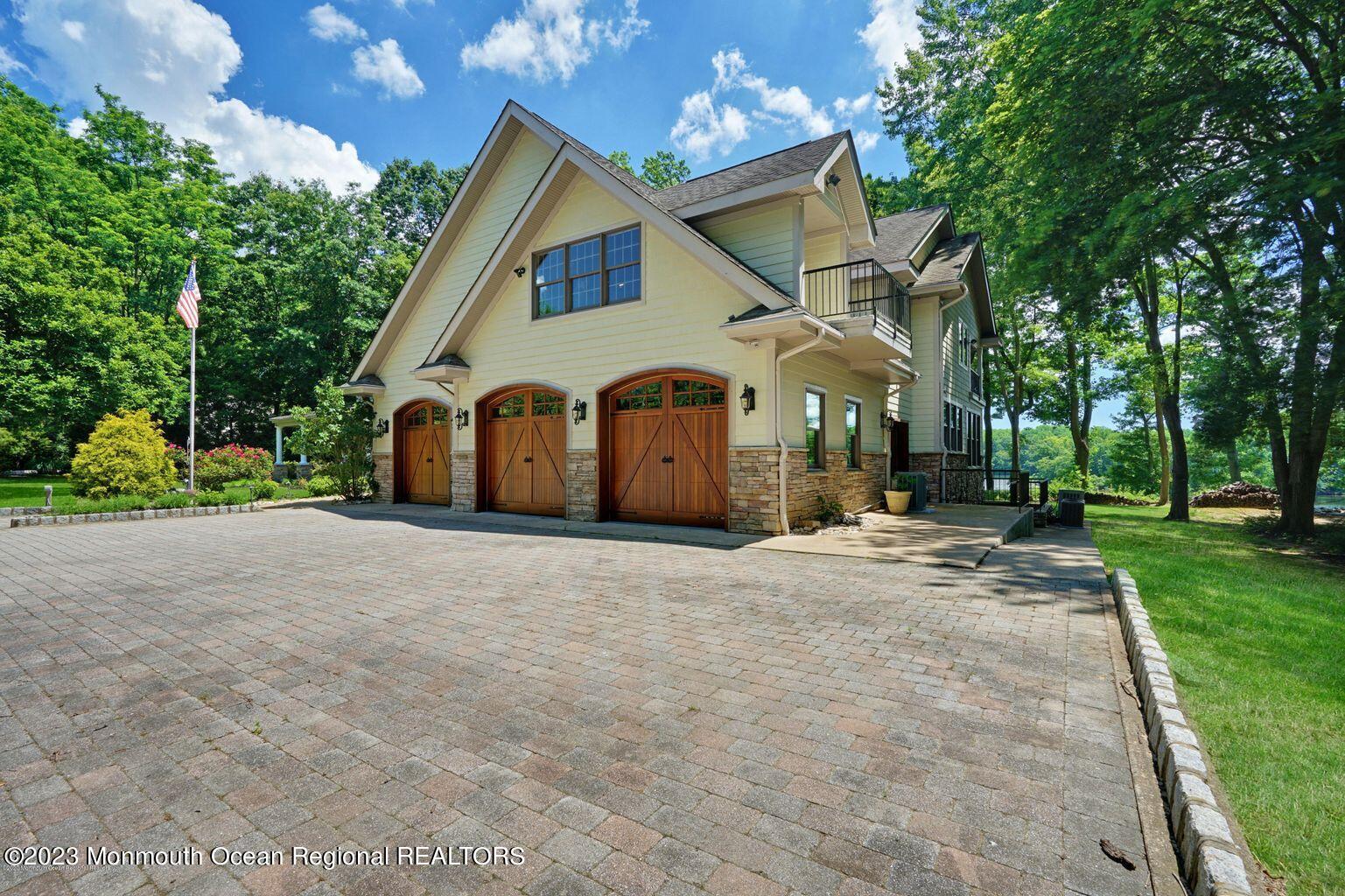 67 Phalanx Road Lincroft, NJ 07738 - Photo 37 of 55 a view of a white house with a big yard and large trees
