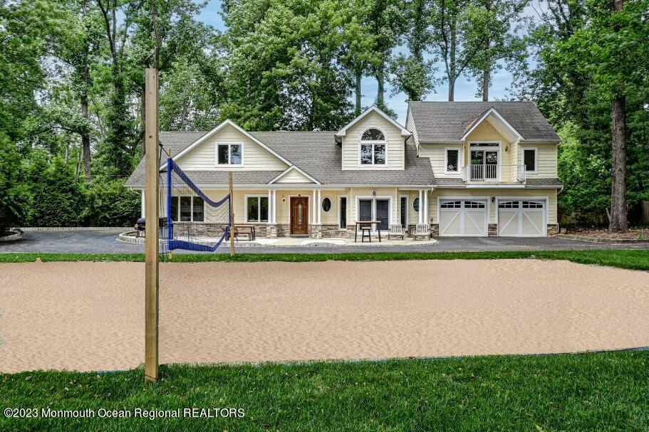 67 Phalanx Road Lincroft, NJ 07738 - Photo 39 of 55 a front view of a house with a yard table and chairs