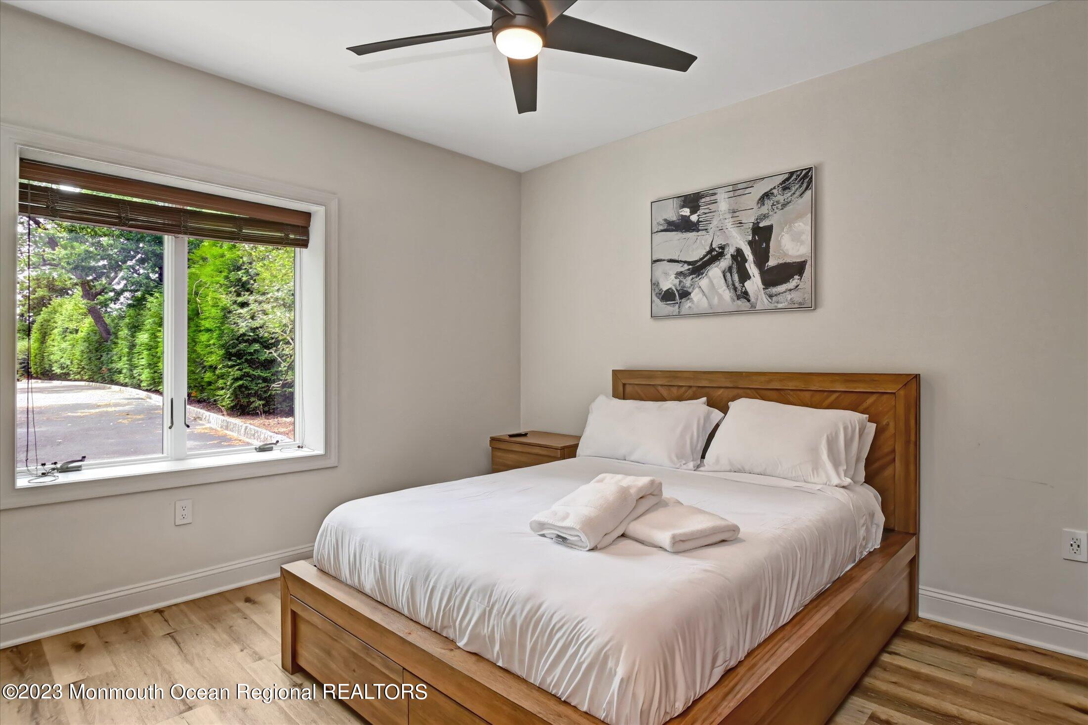 67 Phalanx Road Lincroft, NJ 07738 - Photo 52 of 55 a bedroom with a bed and a large window