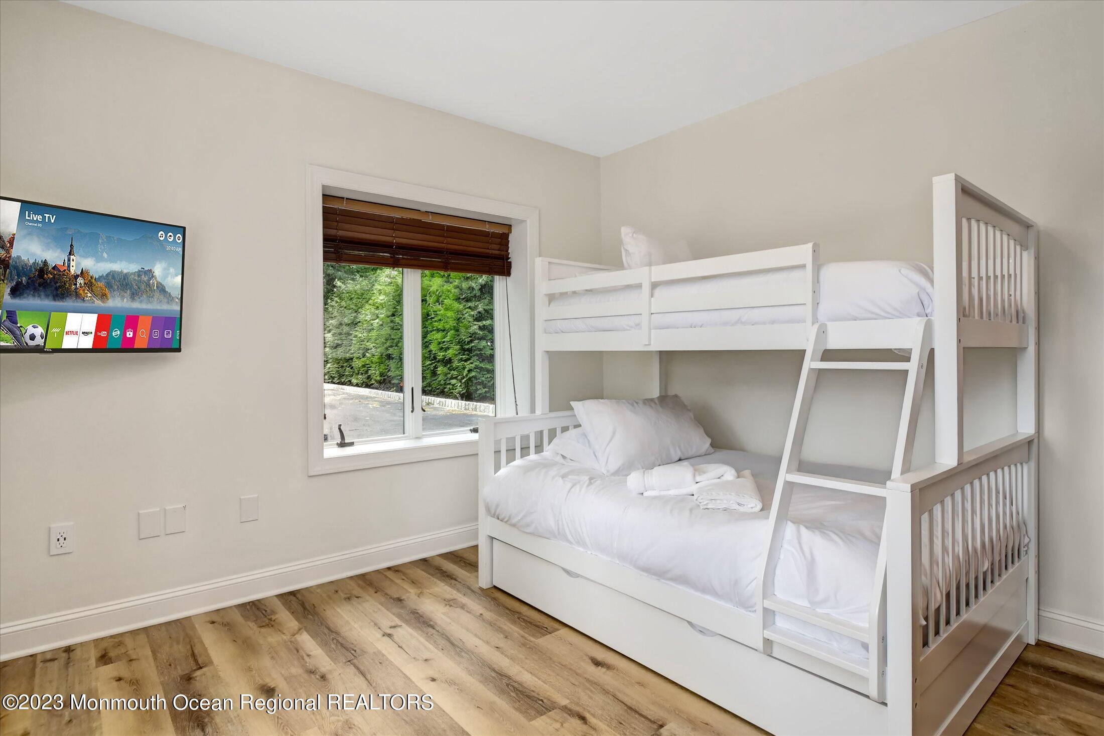 67 Phalanx Road Lincroft, NJ 07738 - Photo 53 of 55 a bedroom with a large bed and a window