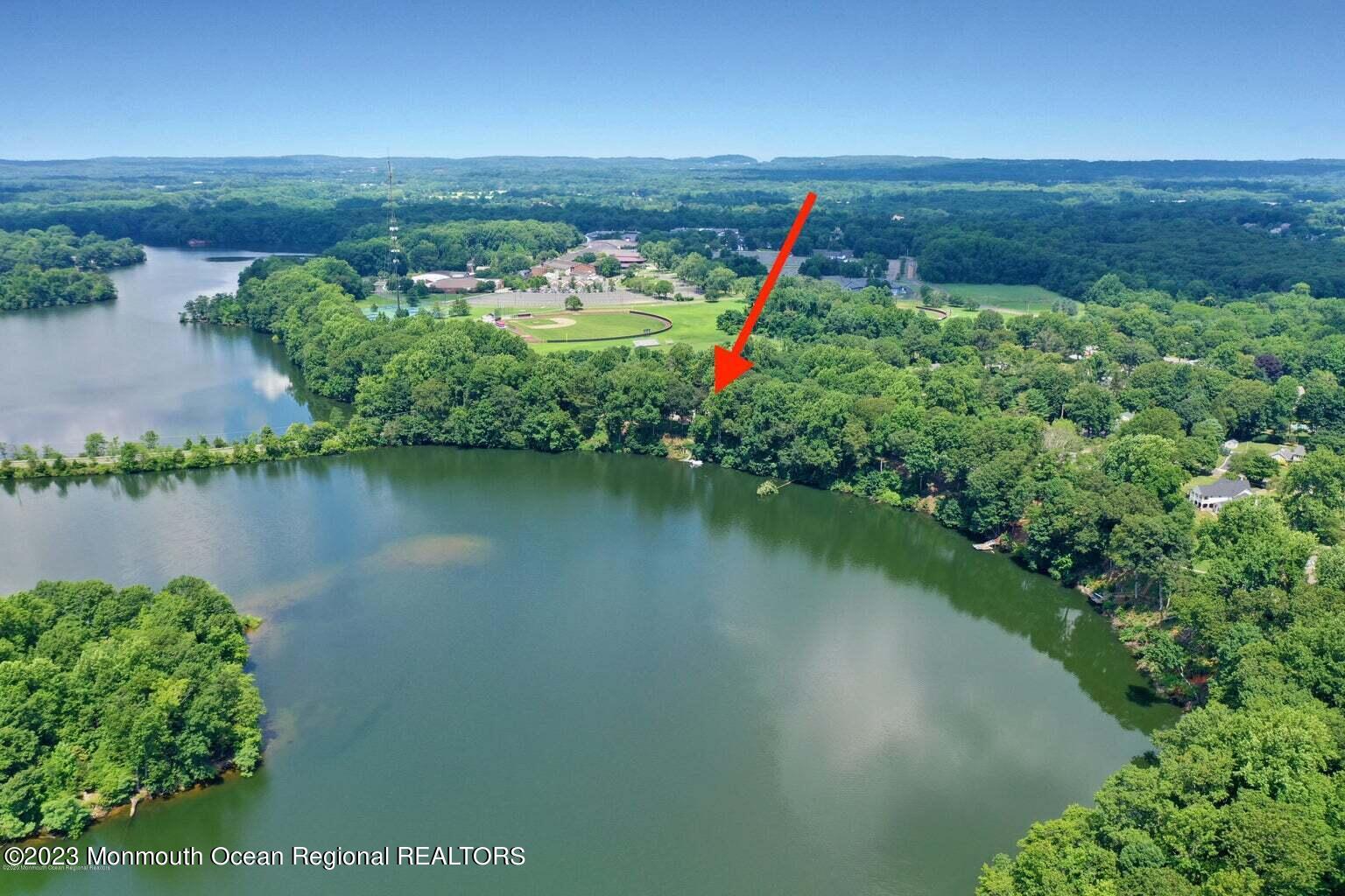 67 Phalanx Road Lincroft, NJ 07738 - Photo 55 of 55 an aerial view of a houses with a yard and lake view