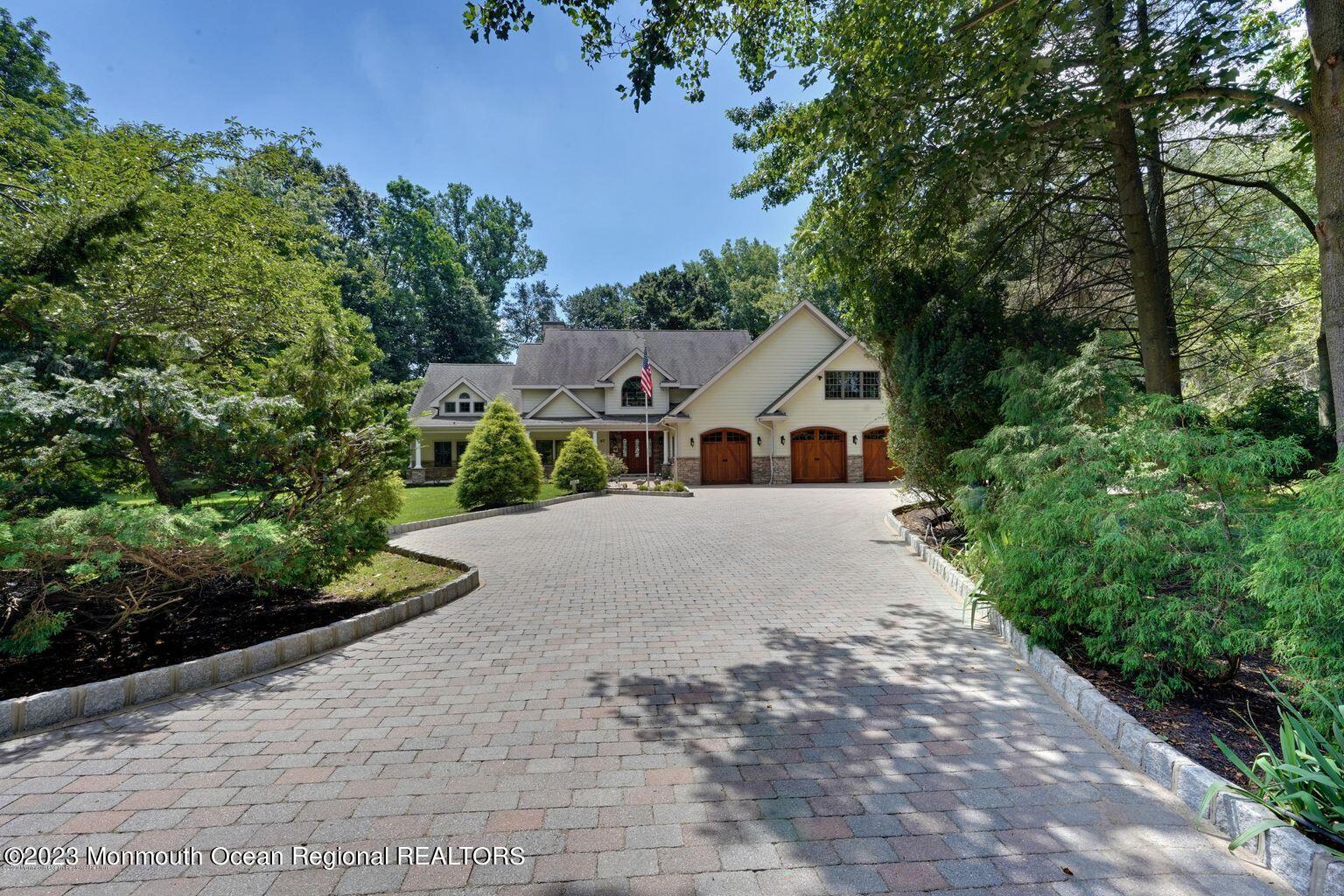 67 Phalanx Road Lincroft, NJ 07738 - Photo 6 of 55 a view of a white house with a yard and potted plants