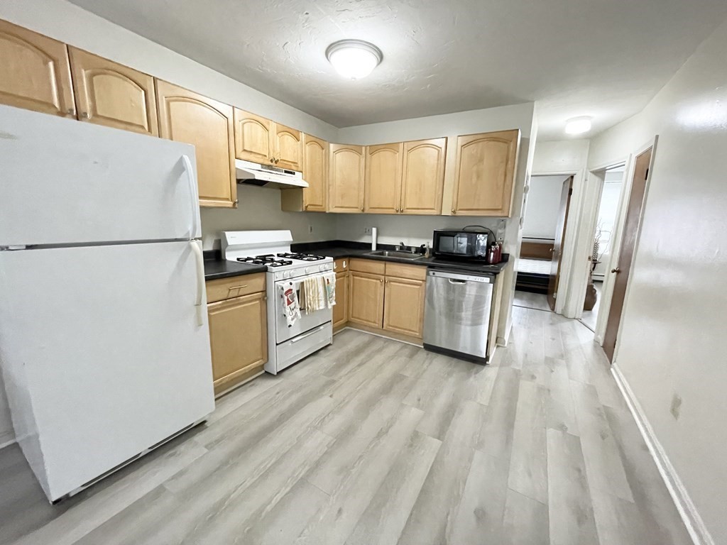 92 Hammond Street, Unit 2 Boston, MA 02120 - Photo 3 of 10 a kitchen with a refrigerator a stove top oven and a refrigerator