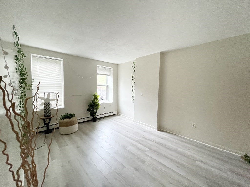 92 Hammond Street, Unit 2 Boston, MA 02120 - Photo 7 of 10 a view of a room with wooden floor and a window