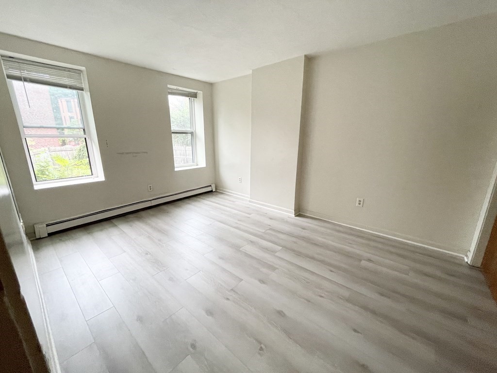 92 Hammond Street, Unit 2 Boston, MA 02120 - Photo 9 of 10 an empty room with wooden floor and windows