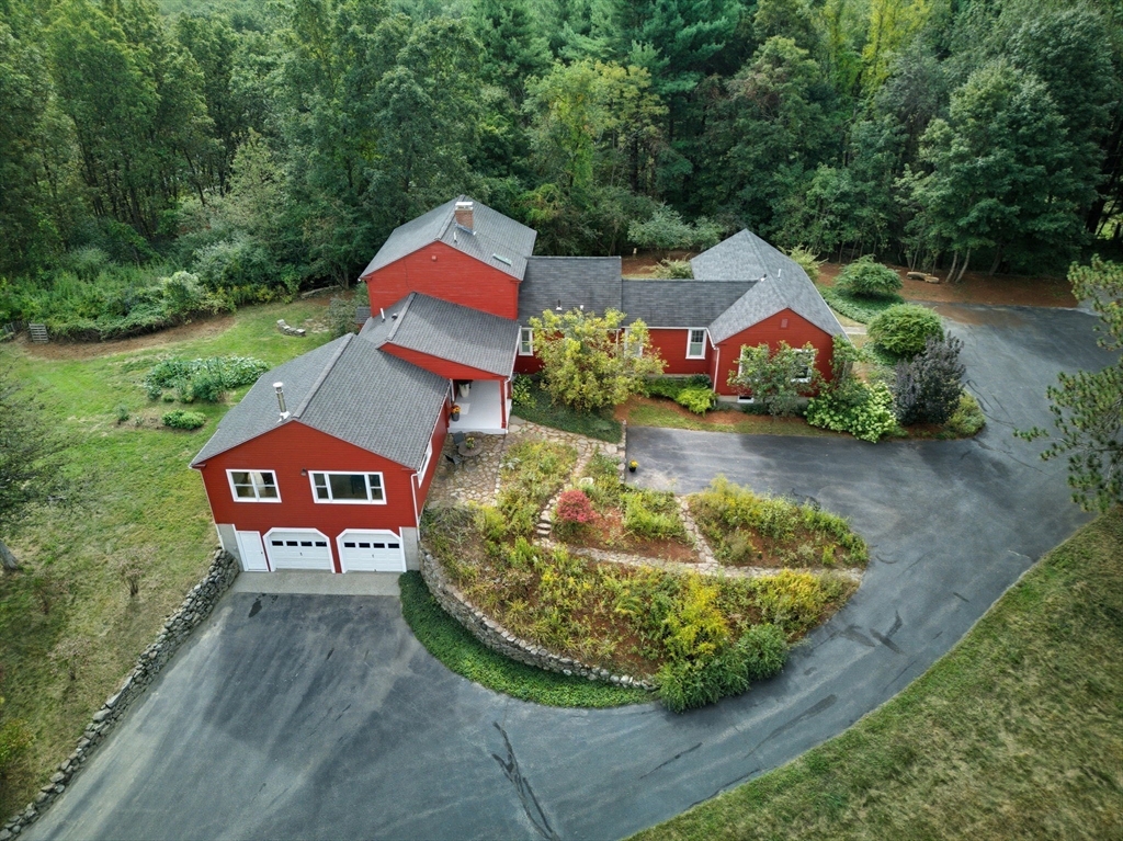 523 Martins Pond Road Groton, MA 01450 - Photo 2 of 4 a sign that is sitting on a wooden bench in a yard