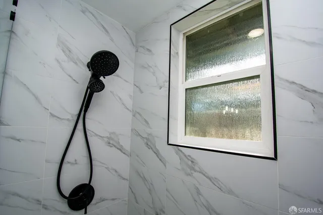 a room with wooden floor and a painting on the wall