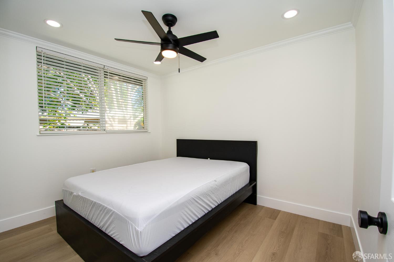 1099 Bradford Drive, Unit A Sunnyvale, CA 94089 - Photo 13 of 16 a bedroom with a bed and a large window