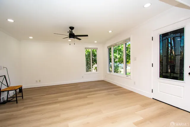 an empty room with windows and natural light