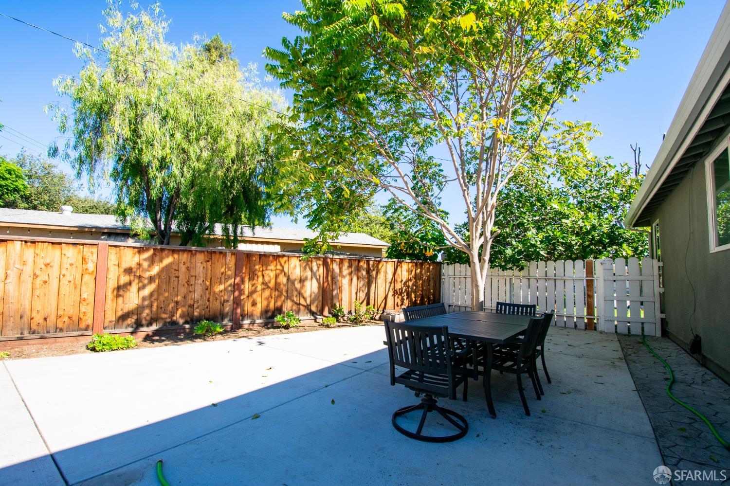 1099 Bradford Drive, Unit A Sunnyvale, CA 94089 - Photo 8 of 16 a view of a tables and chairs in back yard of a house