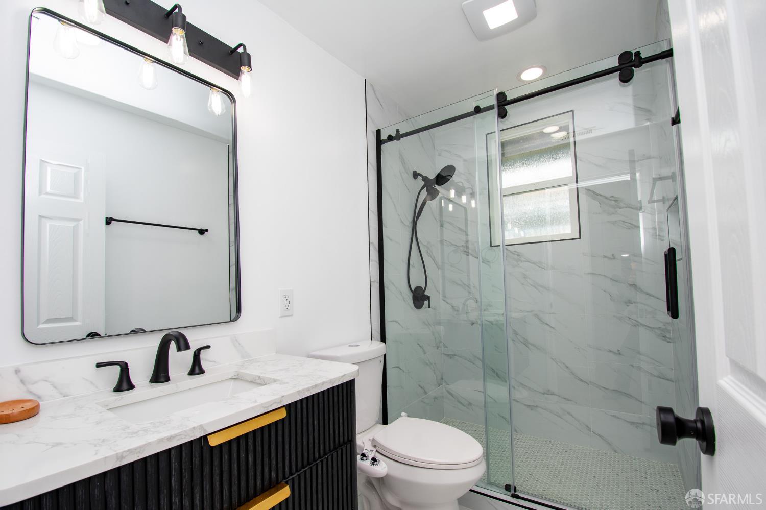 1099 Bradford Drive, Unit A Sunnyvale, CA 94089 - Photo 9 of 16 a bathroom with a granite countertop sink toilet mirror and shower