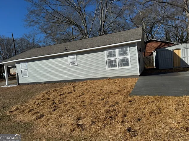a view of a livingroom with wooden floor and a window